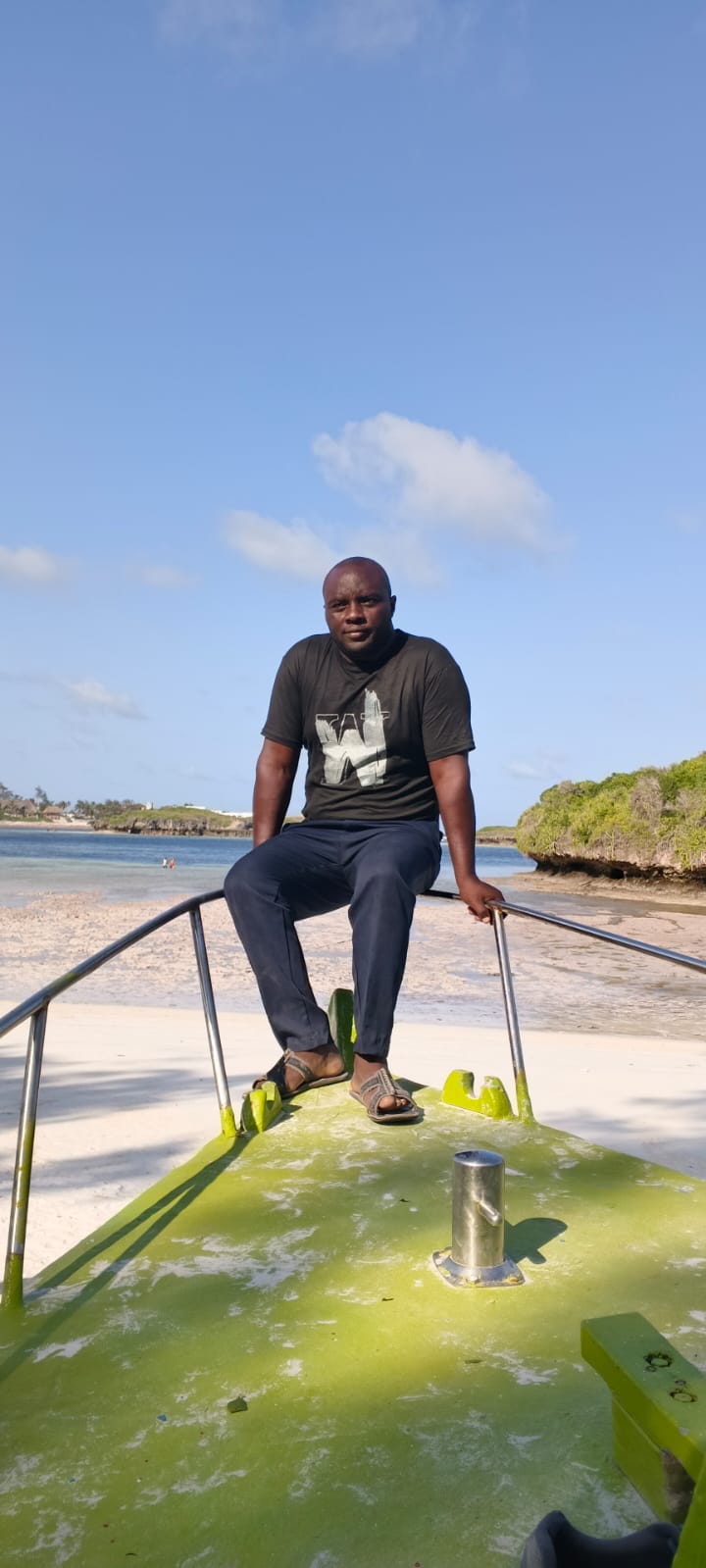 Mose sitting on a boat at Watamu beach, Kenya