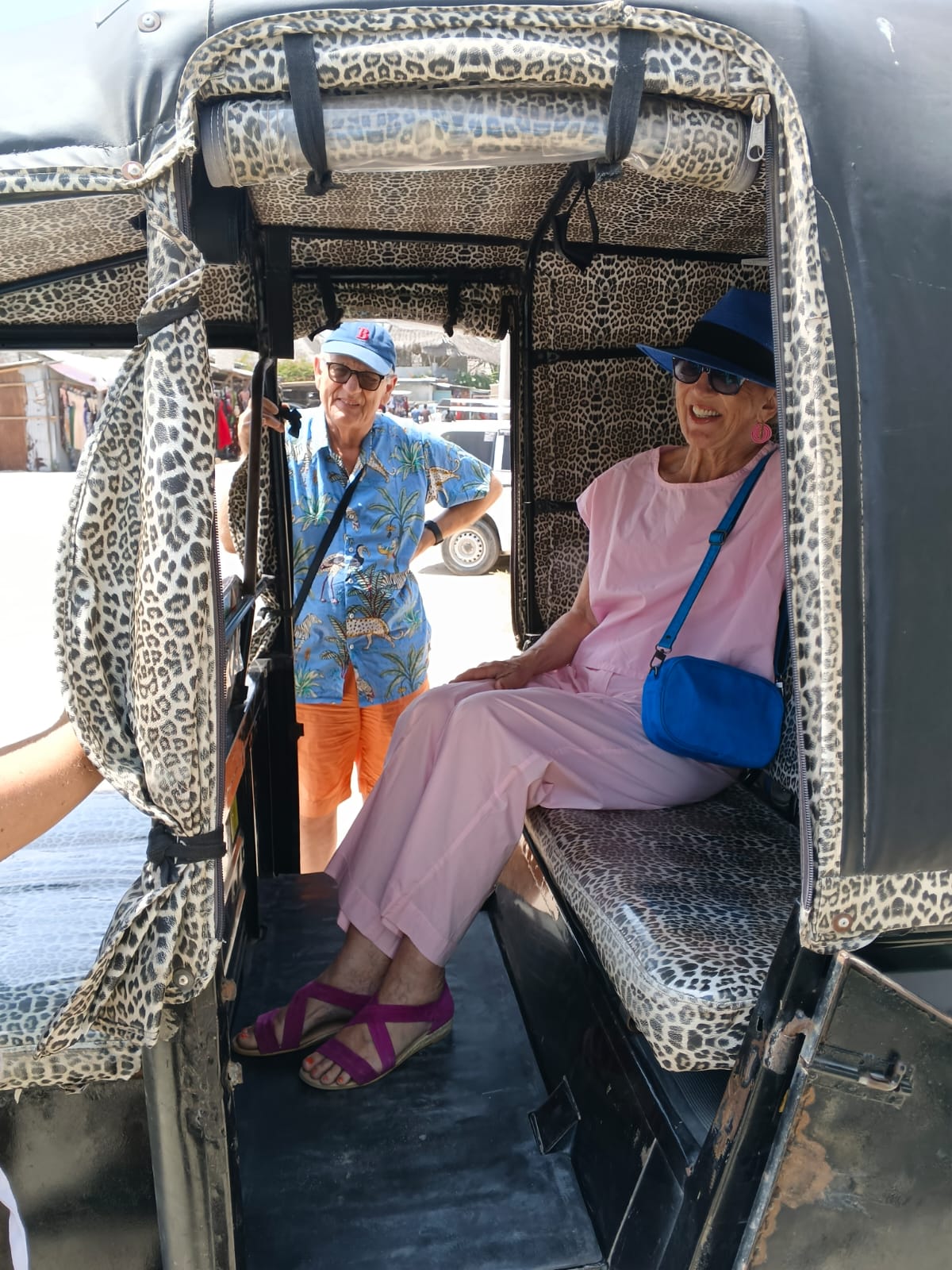 Couple boarding the tuk tuk for a Watamu beach transfer