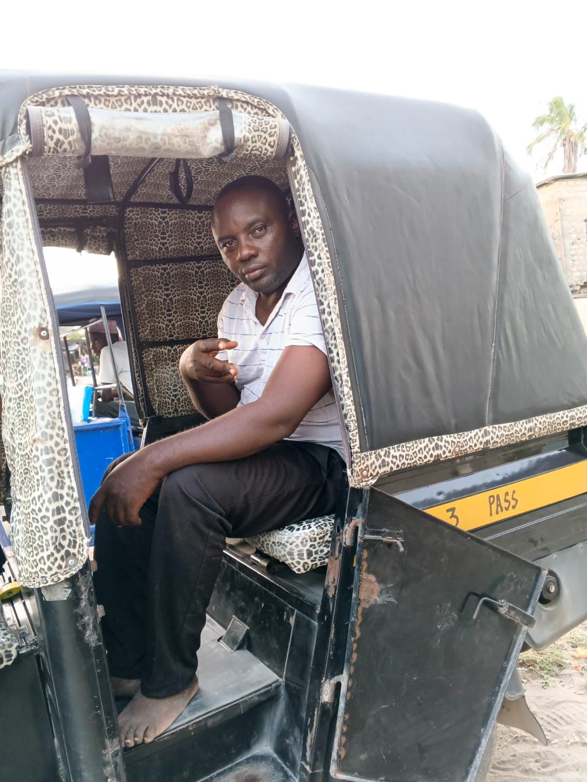 Mose seated in his tuk tuk in Watamu, Kenya