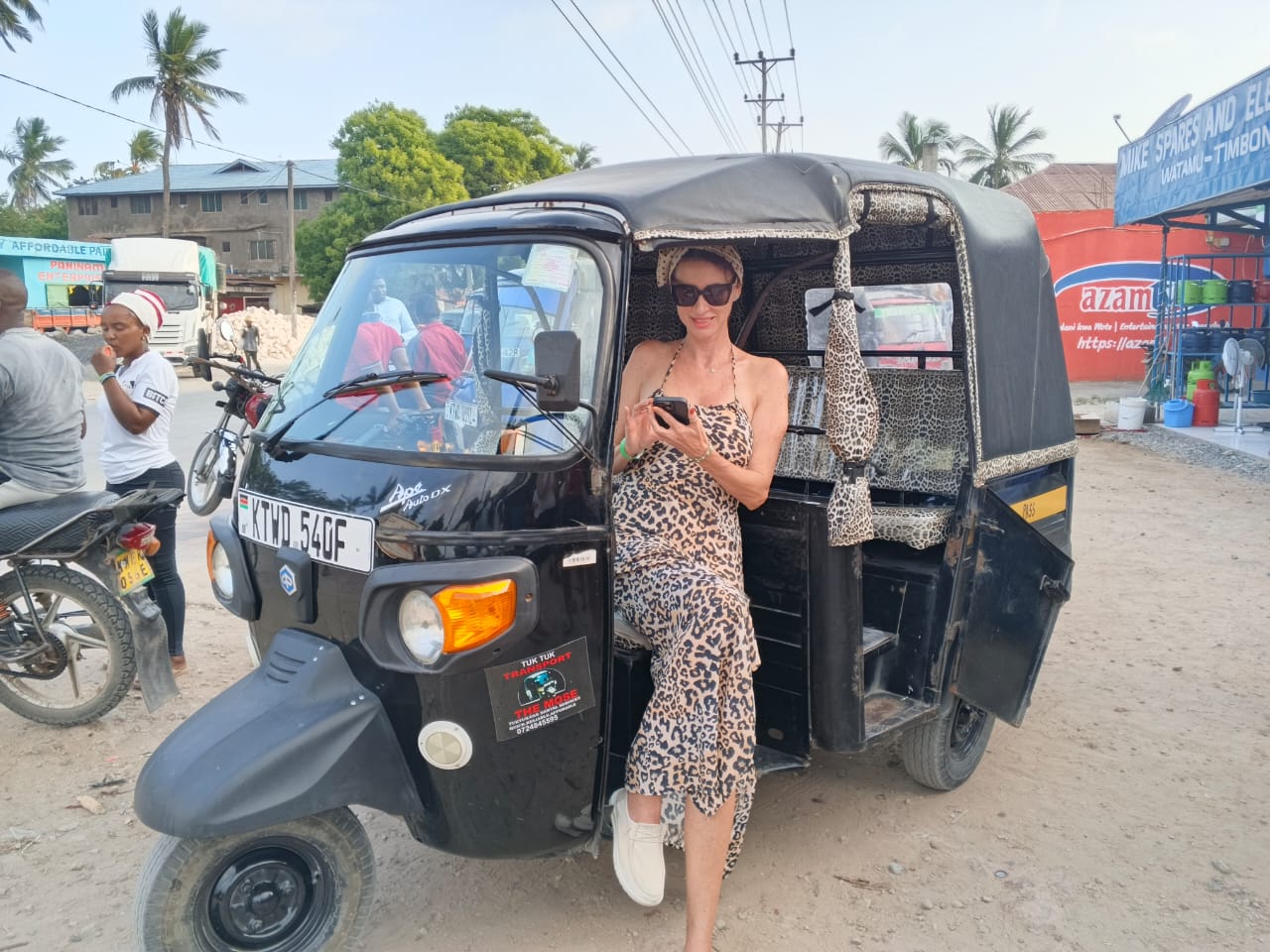 Visitor next to the tuk tuk on a Watamu street